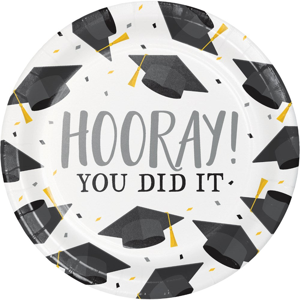 White 7-inch paper plate with black graduation caps and gold tassels, "Hooray! You Did It" text in gray.