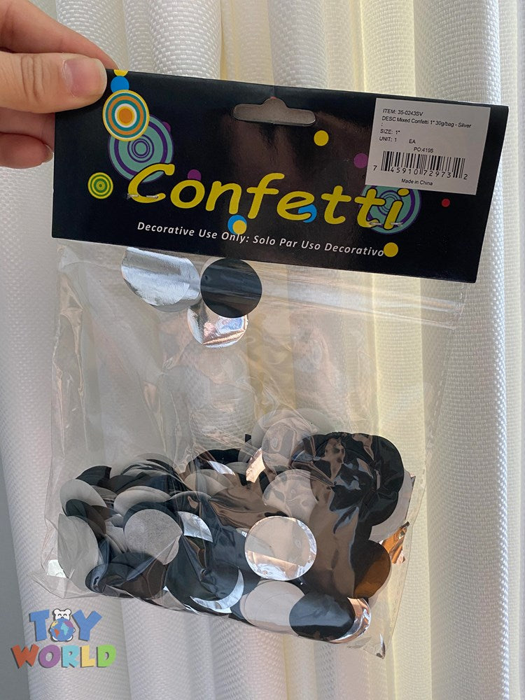 Clear plastic bag filled with silver round confetti discs, labeled "Confetti" on a black header with colorful circle designs.