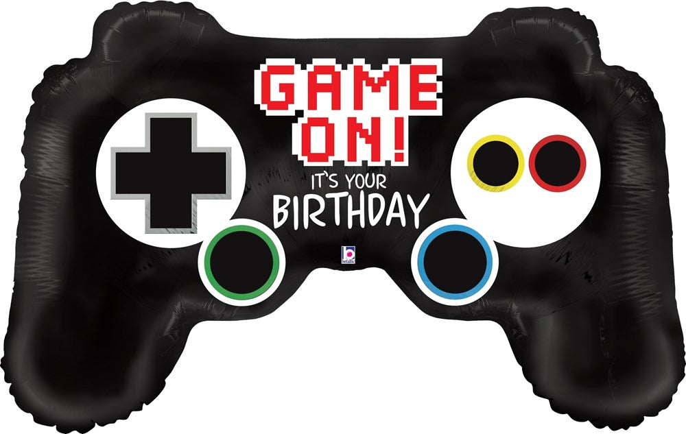Black foil balloon shaped like a video game controller with colorful buttons and "Game On! It's Your Birthday" text in red.