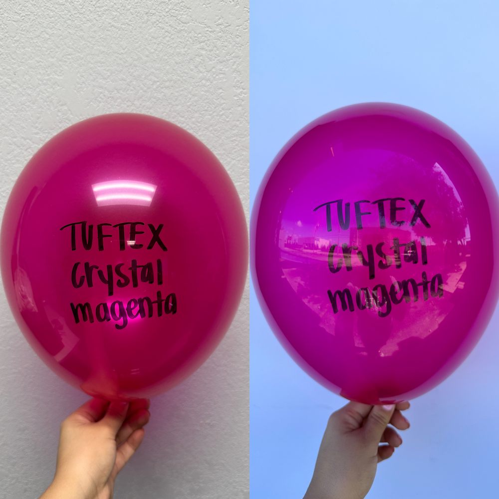 Glossy crystal magenta 36-inch latex balloon with Tuftex Crystal Magenta black print held against white and blue backgrounds.