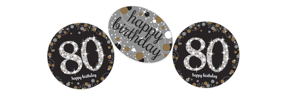Round black confetti discs with silver "80" and "happy birthday" text, sparkling design.