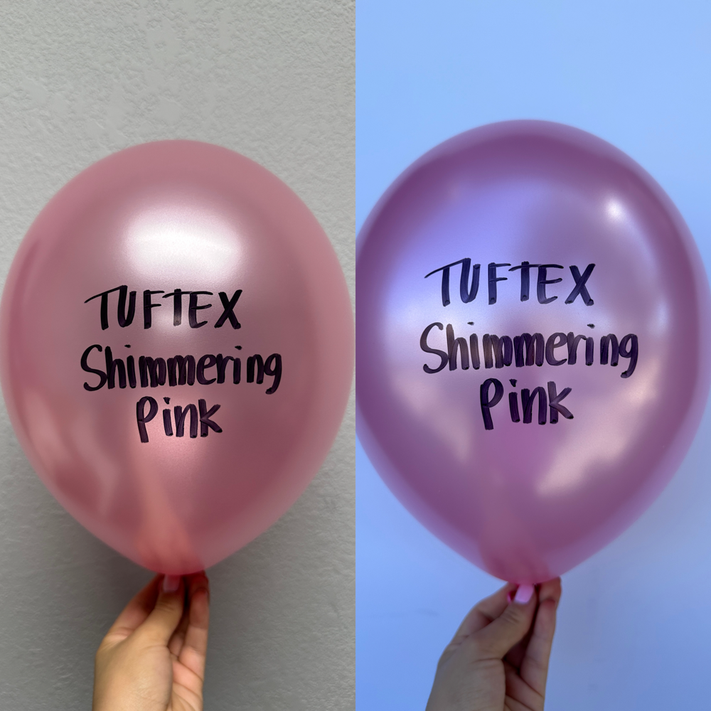 Large 36-inch pearlescent pink latex balloon with shimmering metallic finish, held at the tied end.