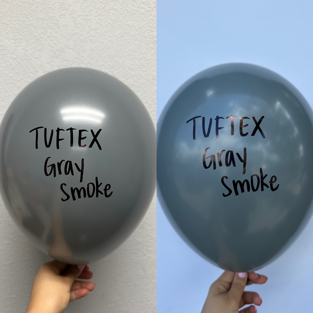 Large 36-inch gray smoke latex balloon with glossy finish and black printed text held against neutral backgrounds.