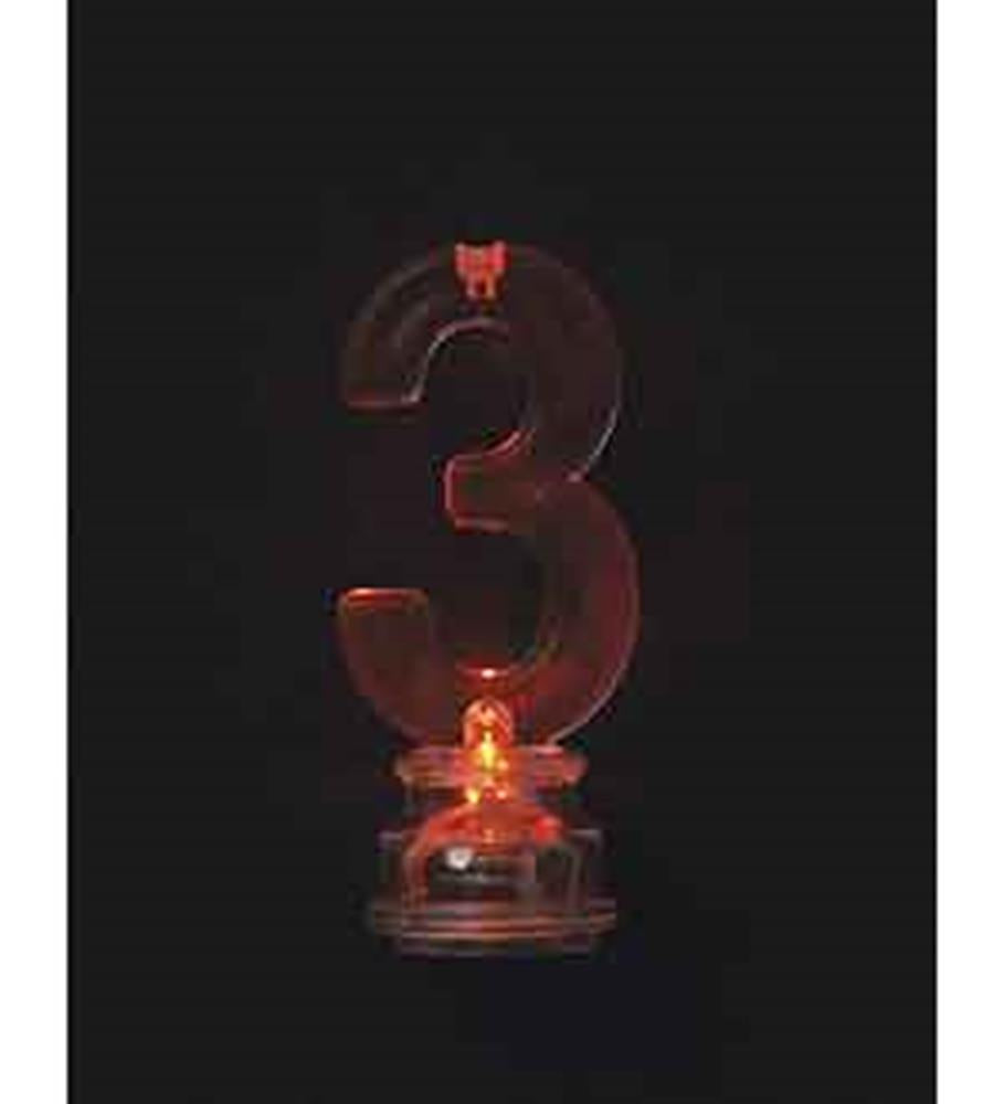 Red number 3 flashing birthday candle holder lit on black background.