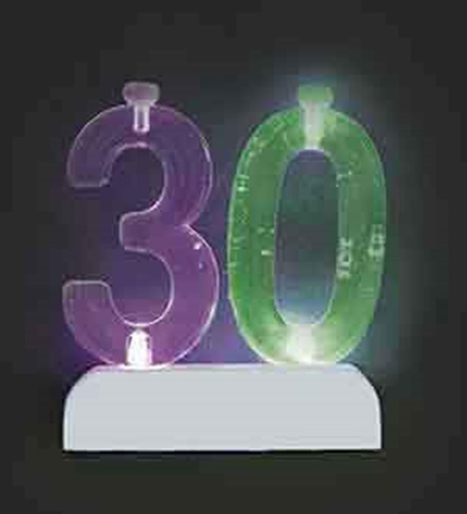 Purple number 3 and green number 0 flashing candles with white base holder.