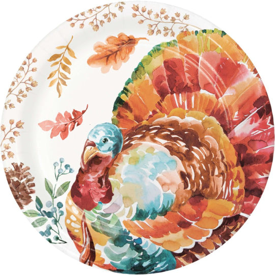 Round paper dinner plate with colorful turkey illustration and autumn leaves on white background.