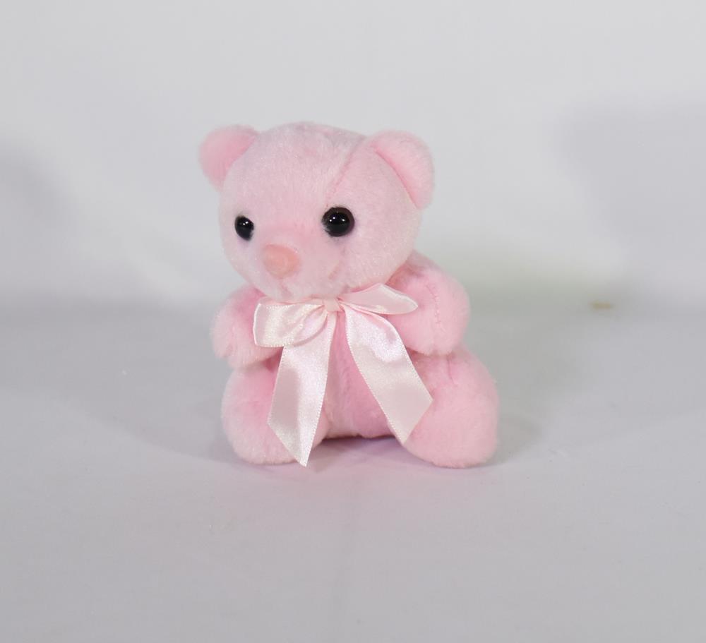 Small pink plush teddy bear with black eyes and a satin pink bow around its neck.
