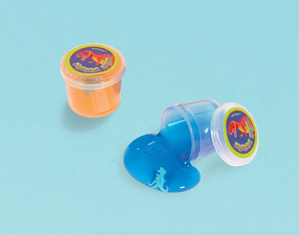 Two small clear plastic containers of slime, one filled with bright orange slime and sealed, the other tipped over spilling.