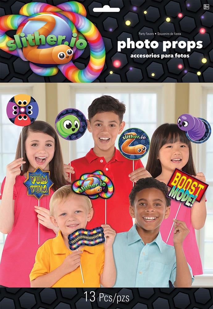 Colorful Slither.Io themed photo props including snake, game icons, and speech bubbles held by smiling children.