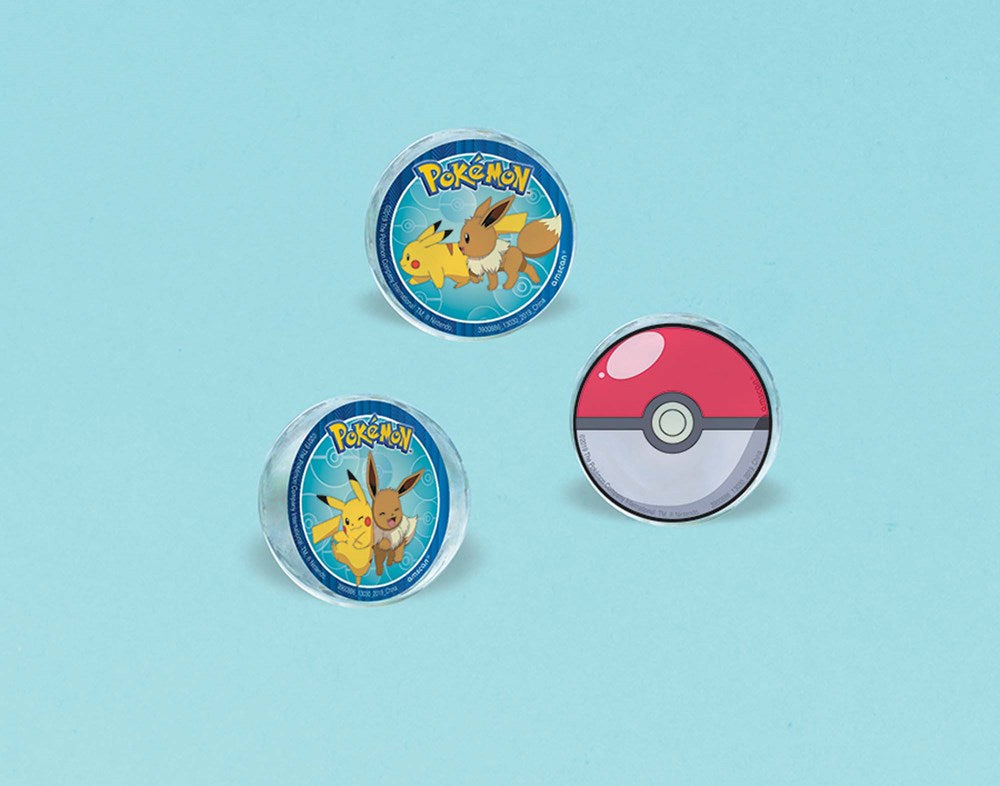 Set of three round bouncy balls featuring colorful Pokemon characters and a Pokeball design on a smooth surface.