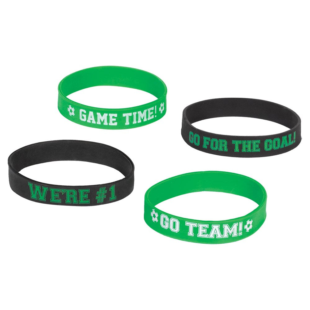Set of four silicone wristbands in green and black with motivational soccer-themed phrases in white and green text.