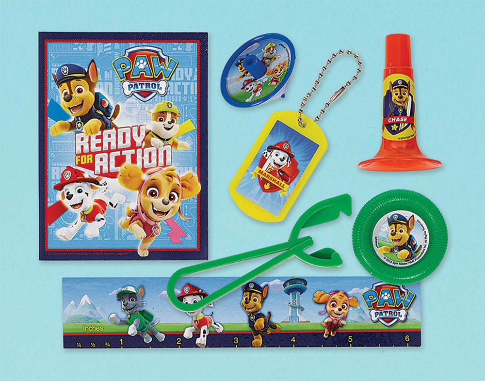 Paw Patrol-themed party favors including a blue and red invitation card, green plastic grabbers, yellow whistle with.