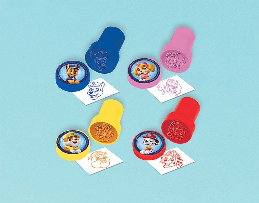 Set of four colorful plastic stampers featuring Paw Patrol characters with matching ink stamps on white paper.