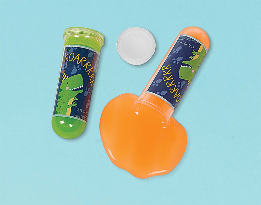 Four-pack of colorful slime containers with dinosaur-themed labels and one opened container showing bright orange slime.