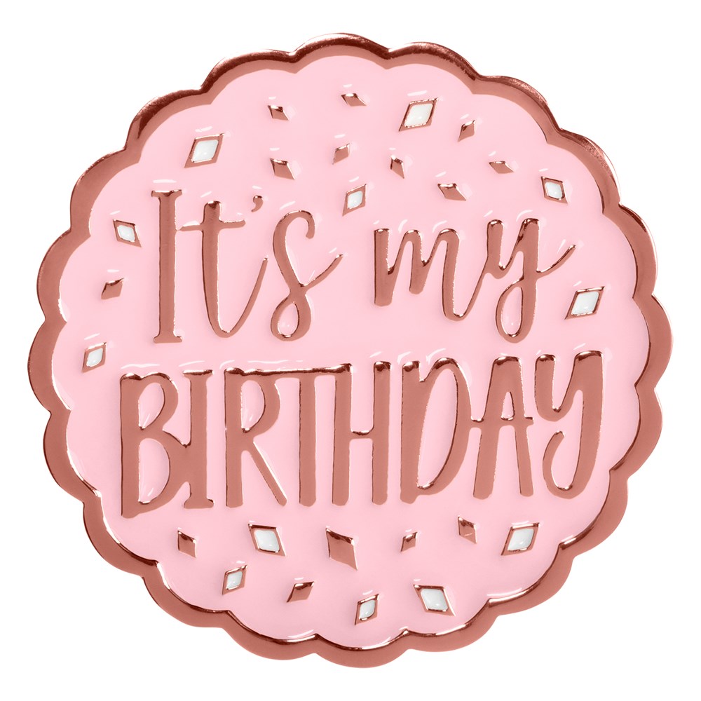 Round blush pink enamel pin with rose gold edges and raised text reading "It's my BIRTHDAY" surrounded by confetti shapes.