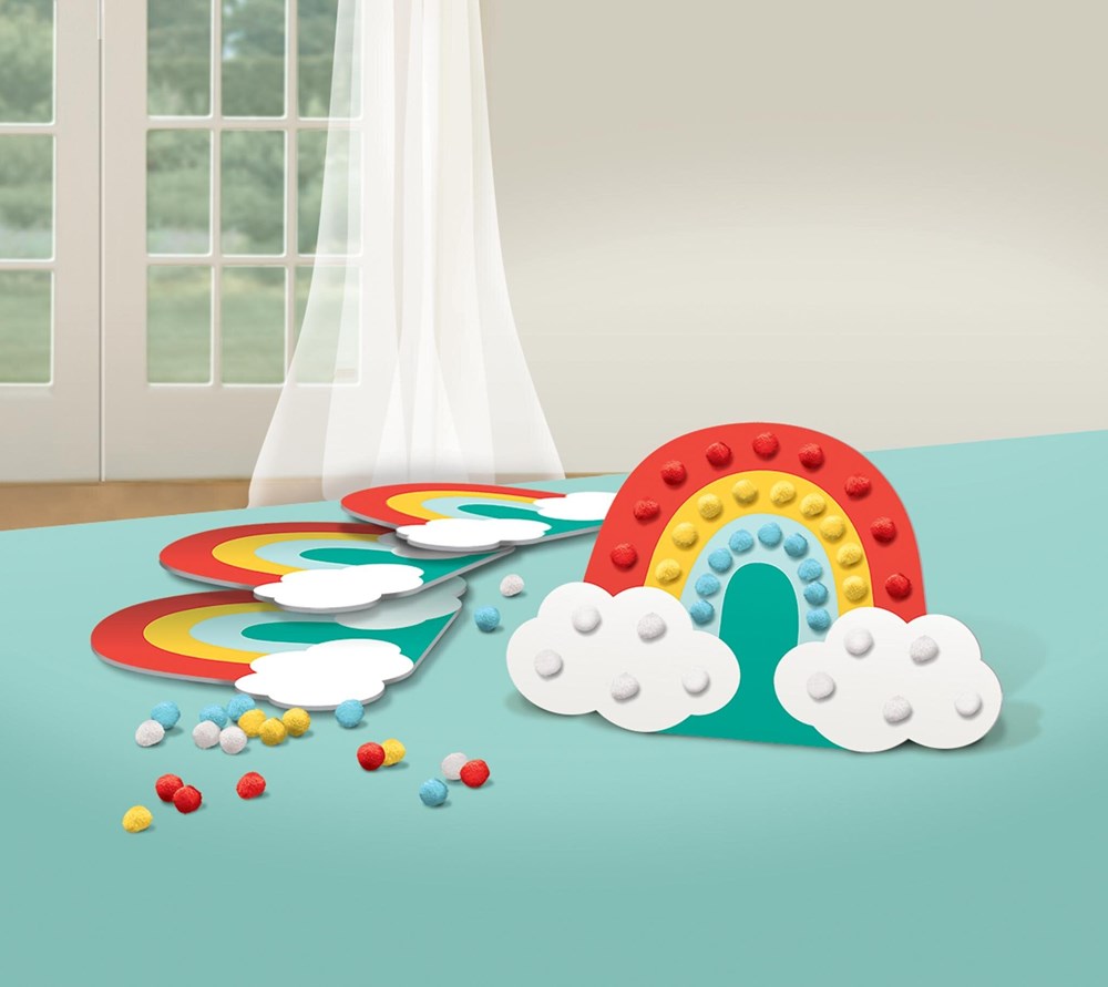 Colorful retro rainbow craft kit with red, orange, yellow, blue, and green arches, white cloud shapes, and small round.