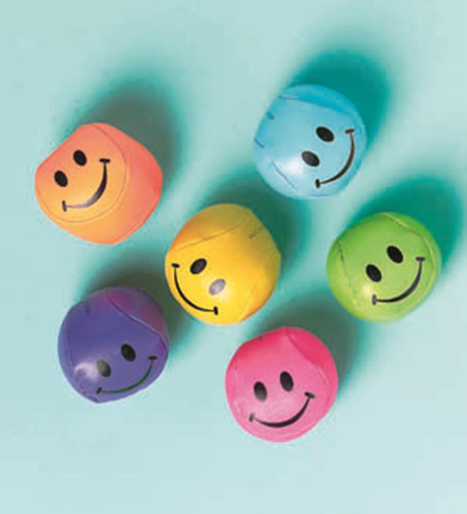 Assorted colorful soft balls with black smiley faces, including orange, blue, yellow, green, purple, and pink balls.