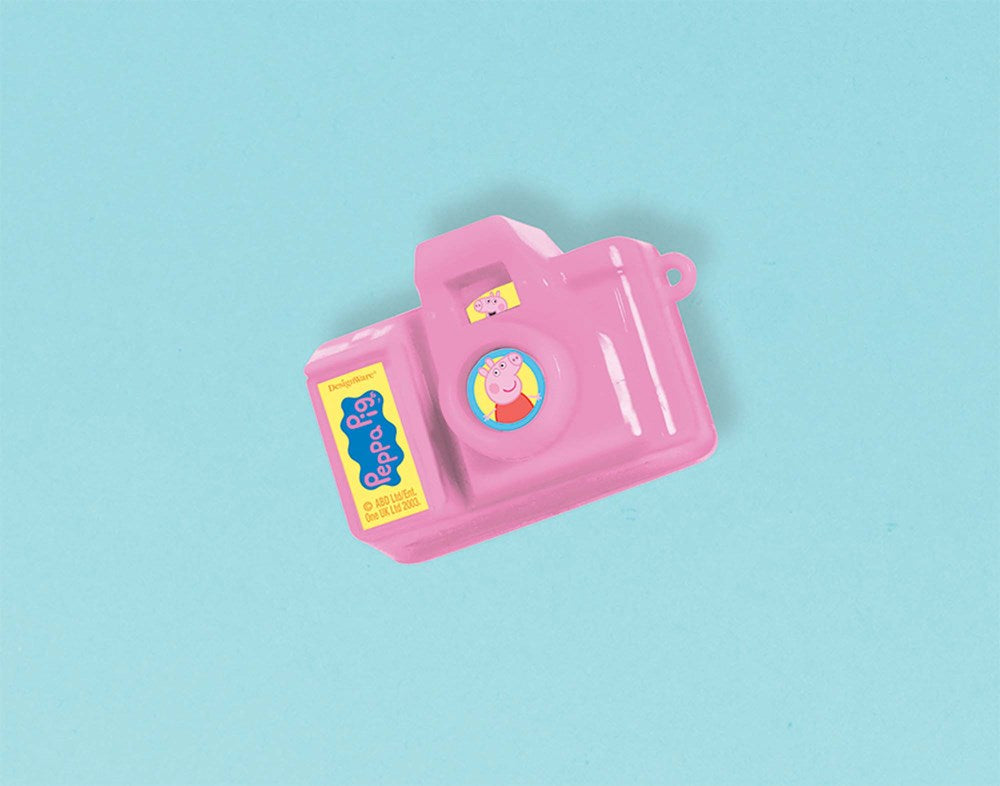 Pink plastic toy camera with Peppa Pig graphic and yellow label on blue background.