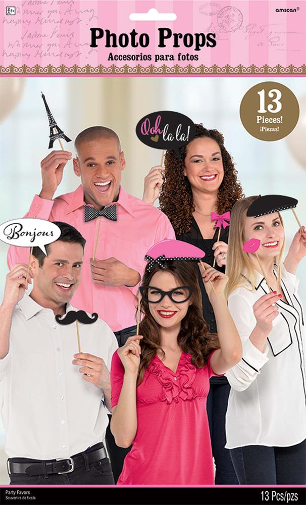 Set of 13 colorful Paris-themed photo props including mustaches, glasses, lips, bow tie, beret, and speech bubbles on sticks.