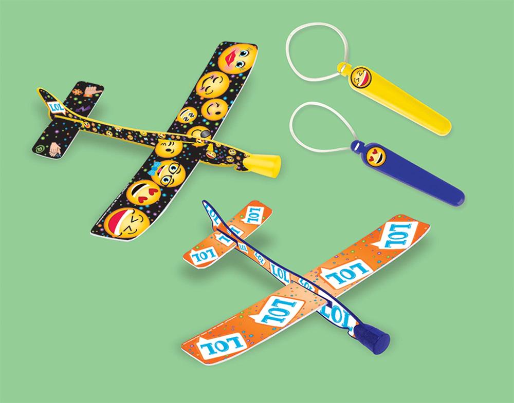 Two foam glider planes with colorful LOL emoji designs, plus two matching keychain gliders in yellow and blue.