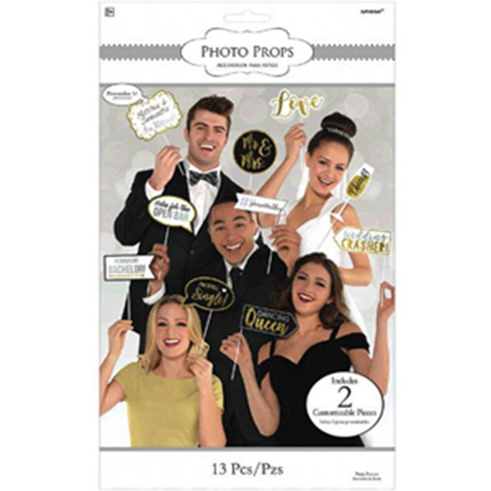 Set of 13 colorful wedding photo props on sticks including speech bubbles, mustache, lips, and celebratory words in gold,.