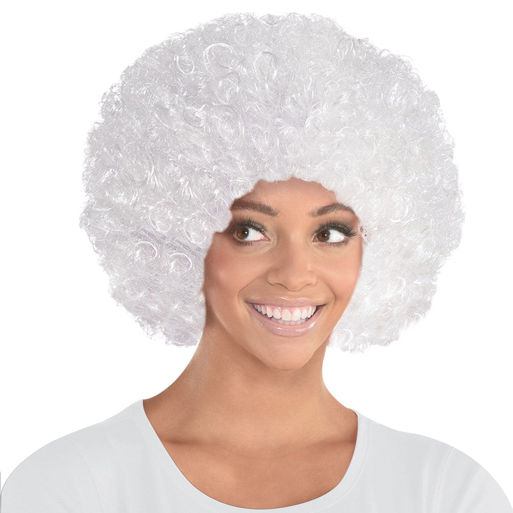 White voluminous curly afro wig on smiling woman wearing white shirt.