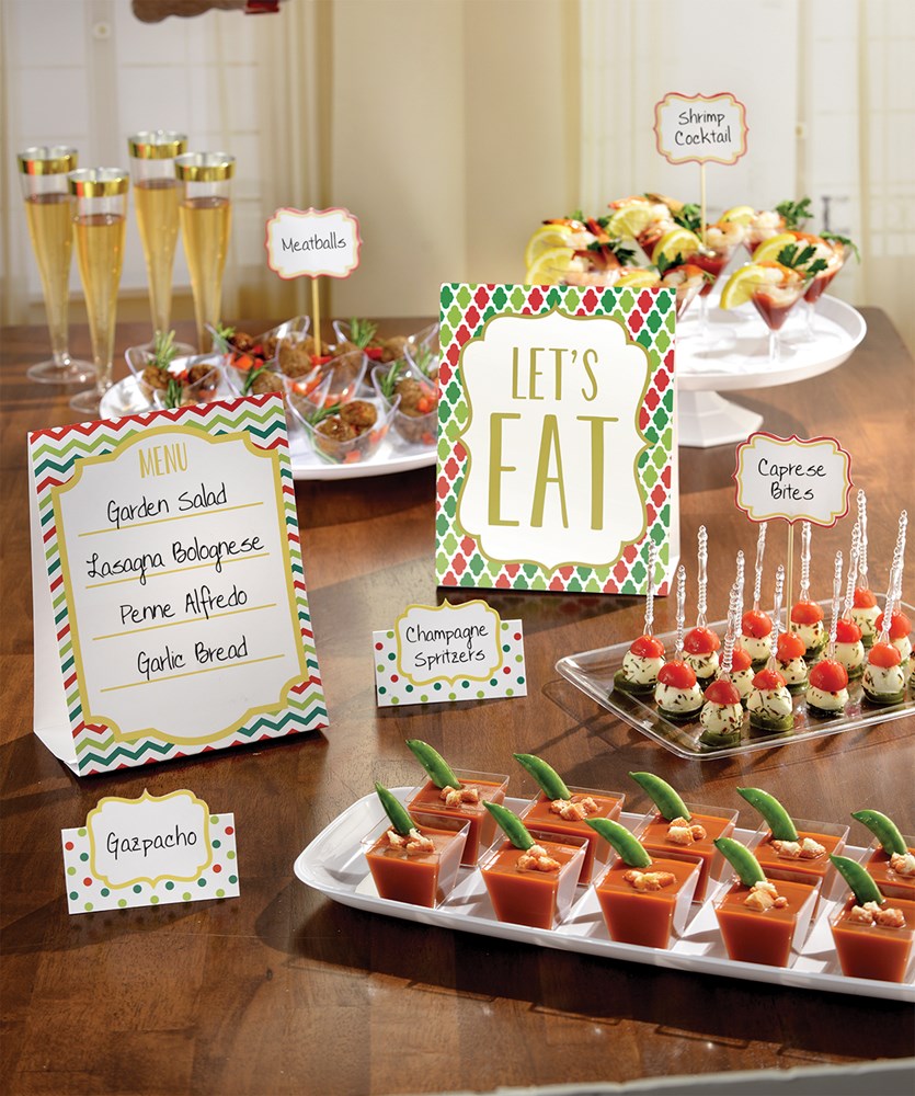 Colorful holiday-themed buffet decoration set with printed signs and menu cards featuring festive patterns and Christmas.