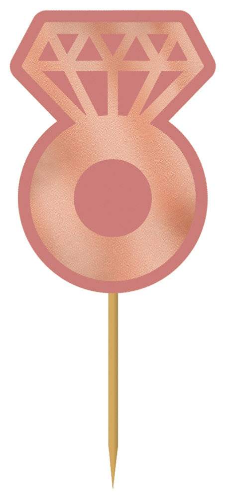 Rose gold ring-shaped pick with geometric diamond cut design on wooden stick.