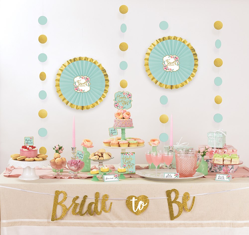 Mint green and gold bridal shower buffet kit with paper fans, string garlands, tiered cupcake stand, and gold "Bride to Be".