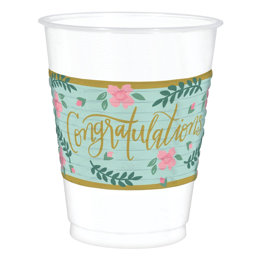Clear plastic cup with a mint green label featuring pink flowers, green leaves, and gold foil "Congratulations" text.