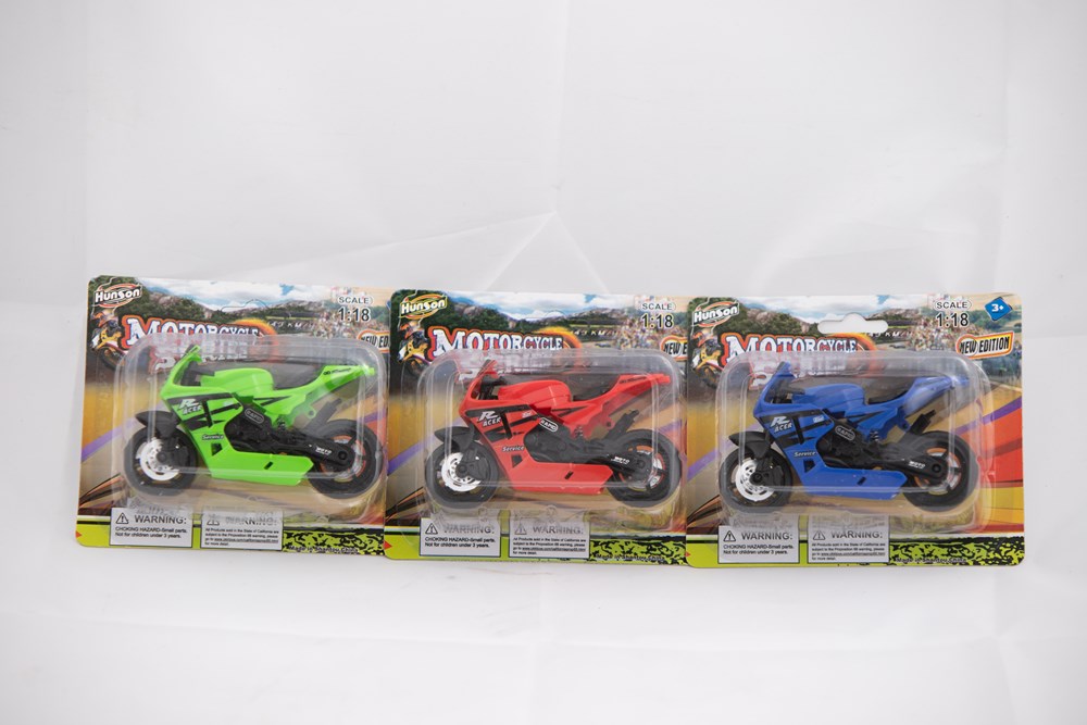 Three colorful plastic toy motorcycles in green, red, and blue, displayed in blister packaging with graphic backgrounds.