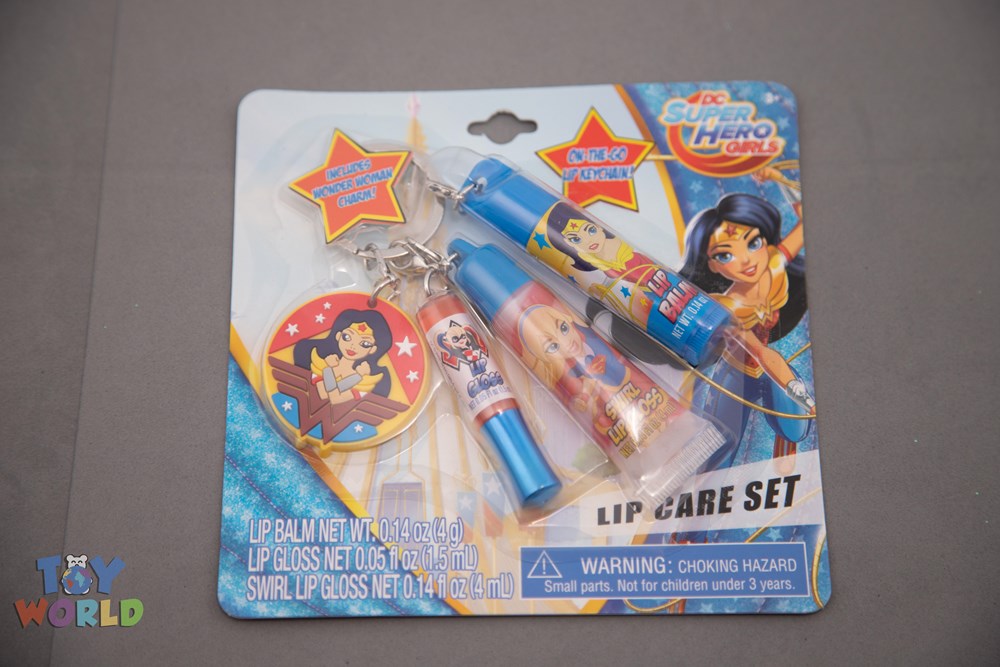 Dc Superhero Girls lip gloss keychain set includes two small tubes with colorful character designs and a star-shaped.