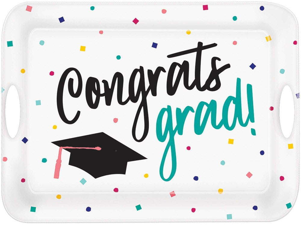 White rectangular plastic serving tray with multicolored confetti, "Congrats grad!" text in black and teal, and a black.