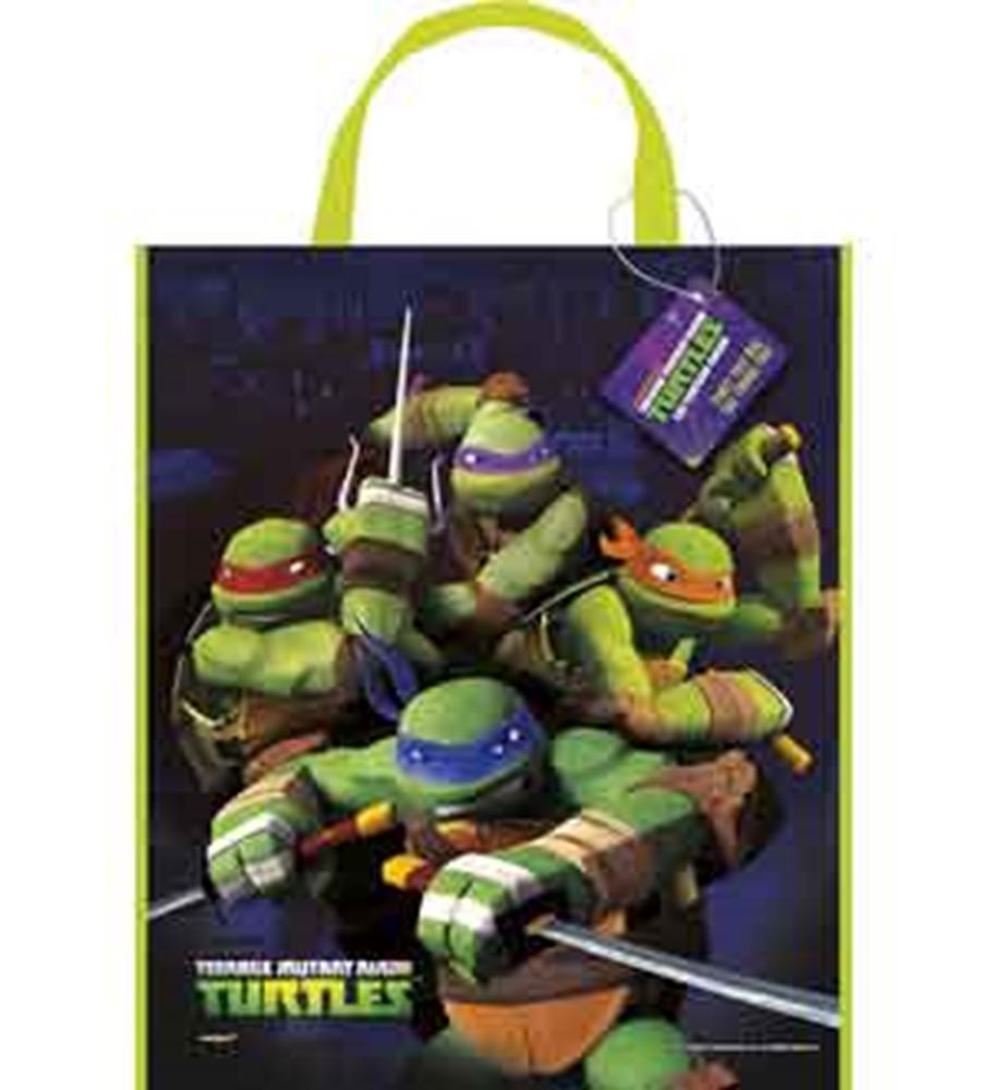 Black tote bag with green handles featuring Teenage Mutant Ninja Turtles in action poses and colorful logo.