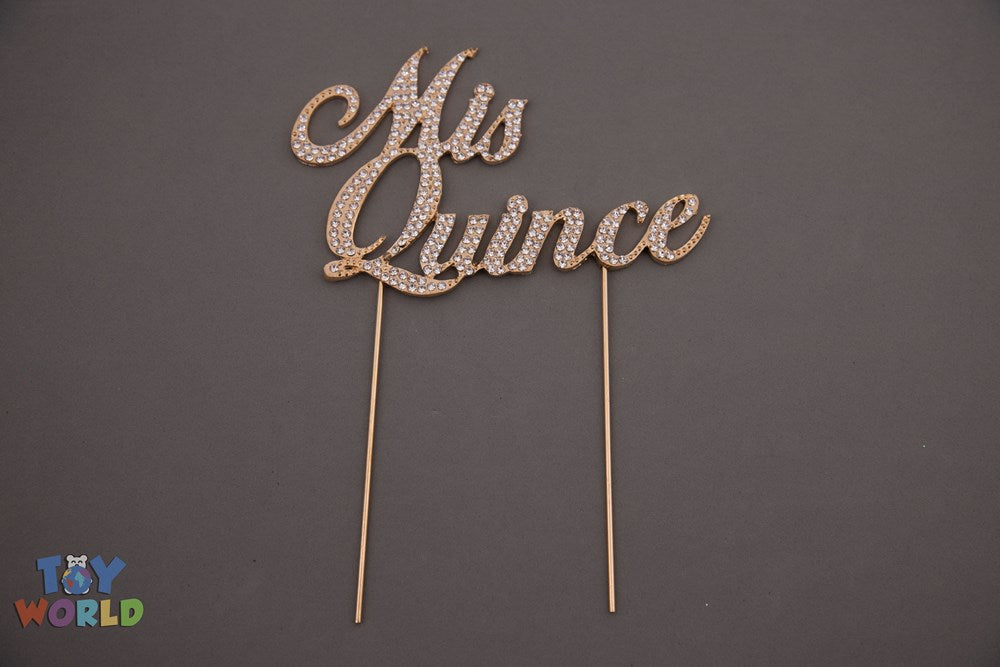 Gold rhinestone "Mis Quince" script cake topper with two long prongs for securing.