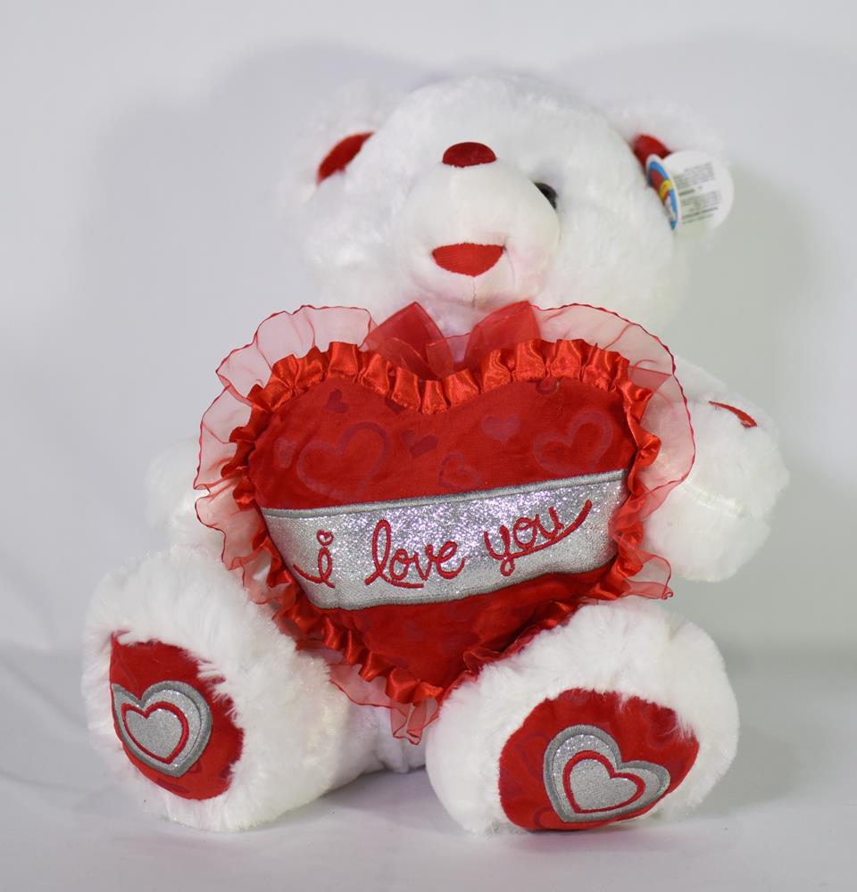 White plush teddy bear holding a red heart with "I love you" text, heart accents on paws.