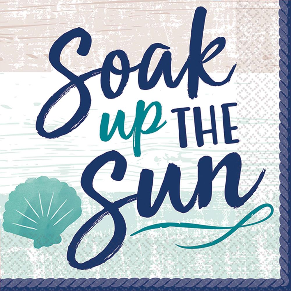 White paper napkin with scalloped teal edges, featuring navy and teal script text "Soak up the sun" and a teal seashell.