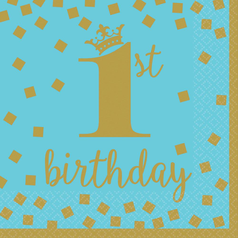 Blue paper napkin with gold foil "1st birthday" text, crown accent, and scattered confetti squares.