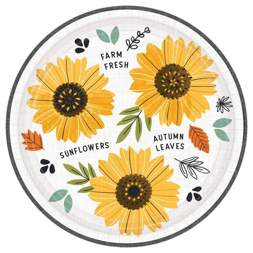 Round white disposable plate with three large yellow sunflowers, green leaves, and orange autumn leaves design.