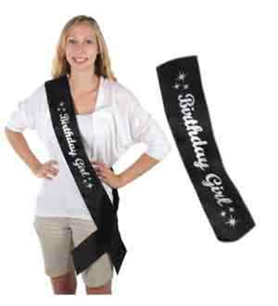 Black satin sash with white "Birthday Girl" text and star accents, worn diagonally across the body.