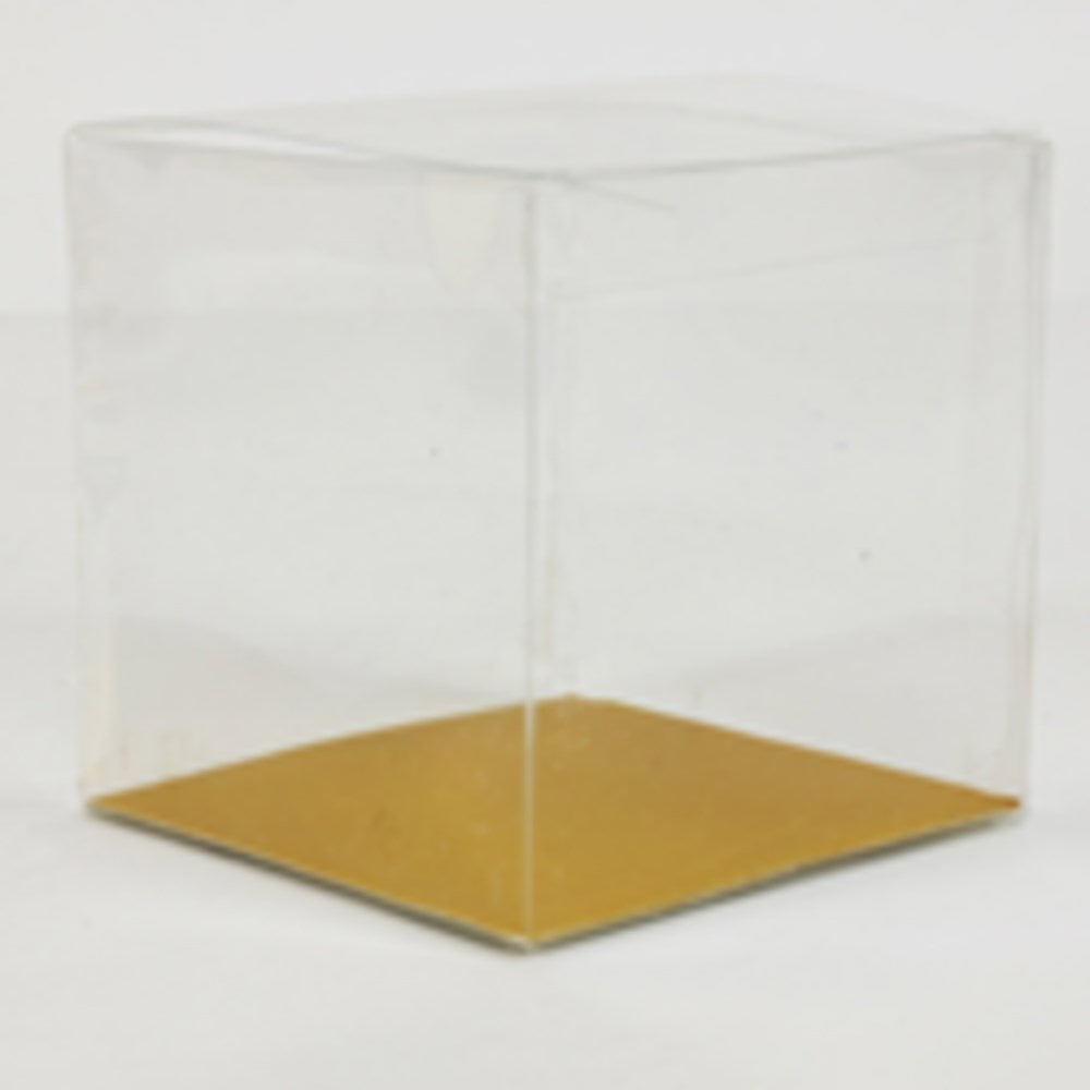 Clear plastic cube favor box with gold-colored bottom, 3.5-inch sides.