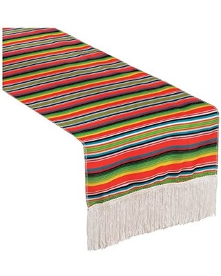 Colorful serape stripe table runner with red, green, yellow, blue stripes and white fringe ends.