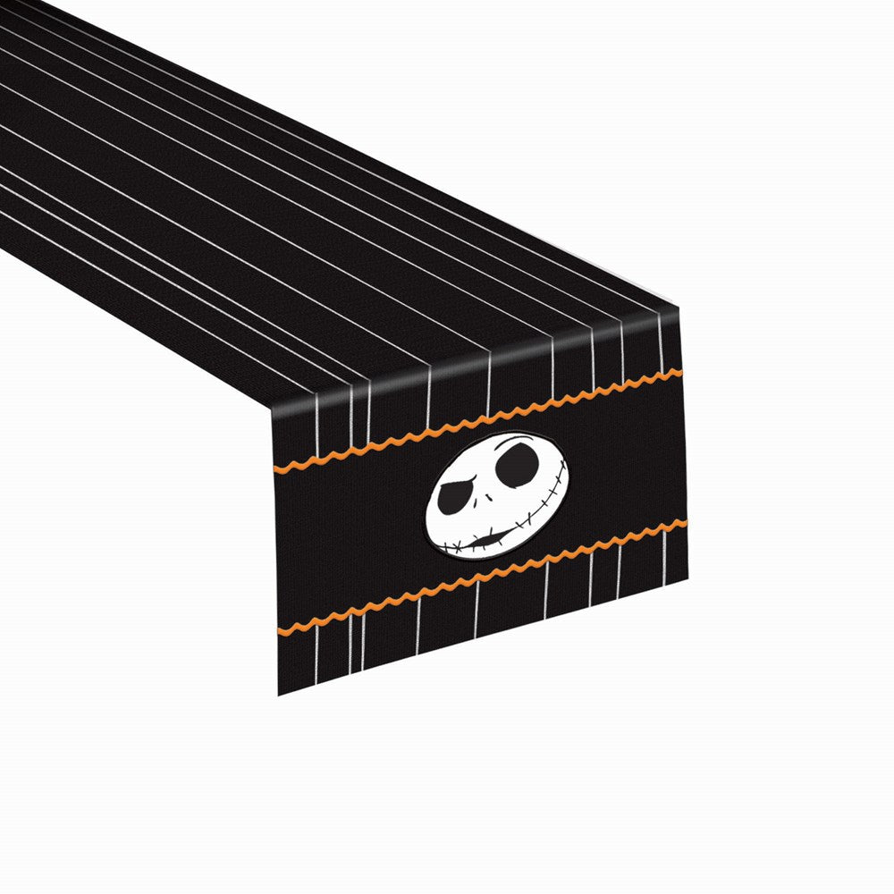 Black table runner with white pinstripes, orange wavy borders, and a white Jack Skellington face in the center.
