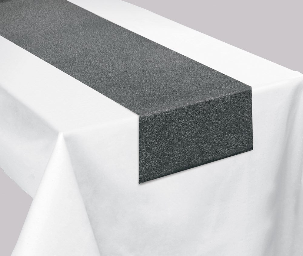 Gray hemstitch fabric table runner on a white tablecloth with a textured weave.