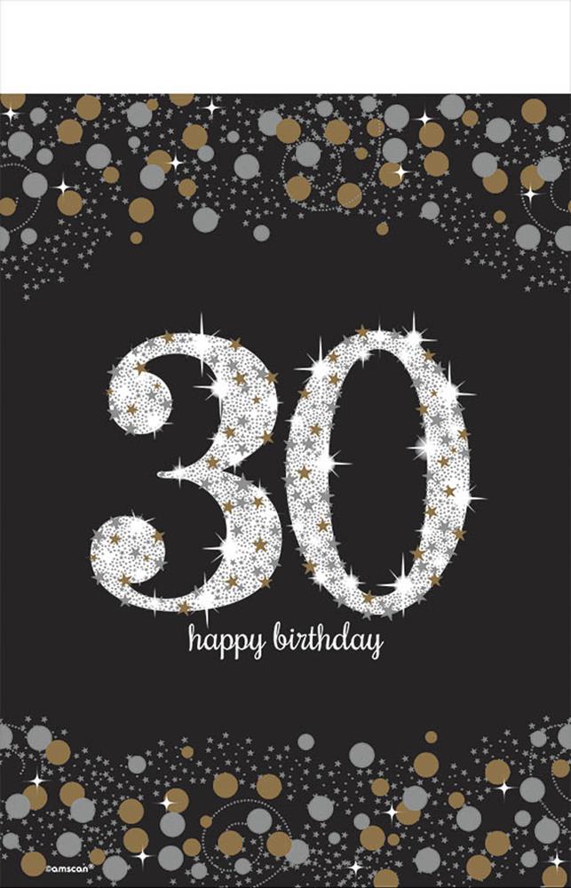 Black plastic table cover with large glittering "30" and "happy birthday" text surrounded by gold, silver, and white.