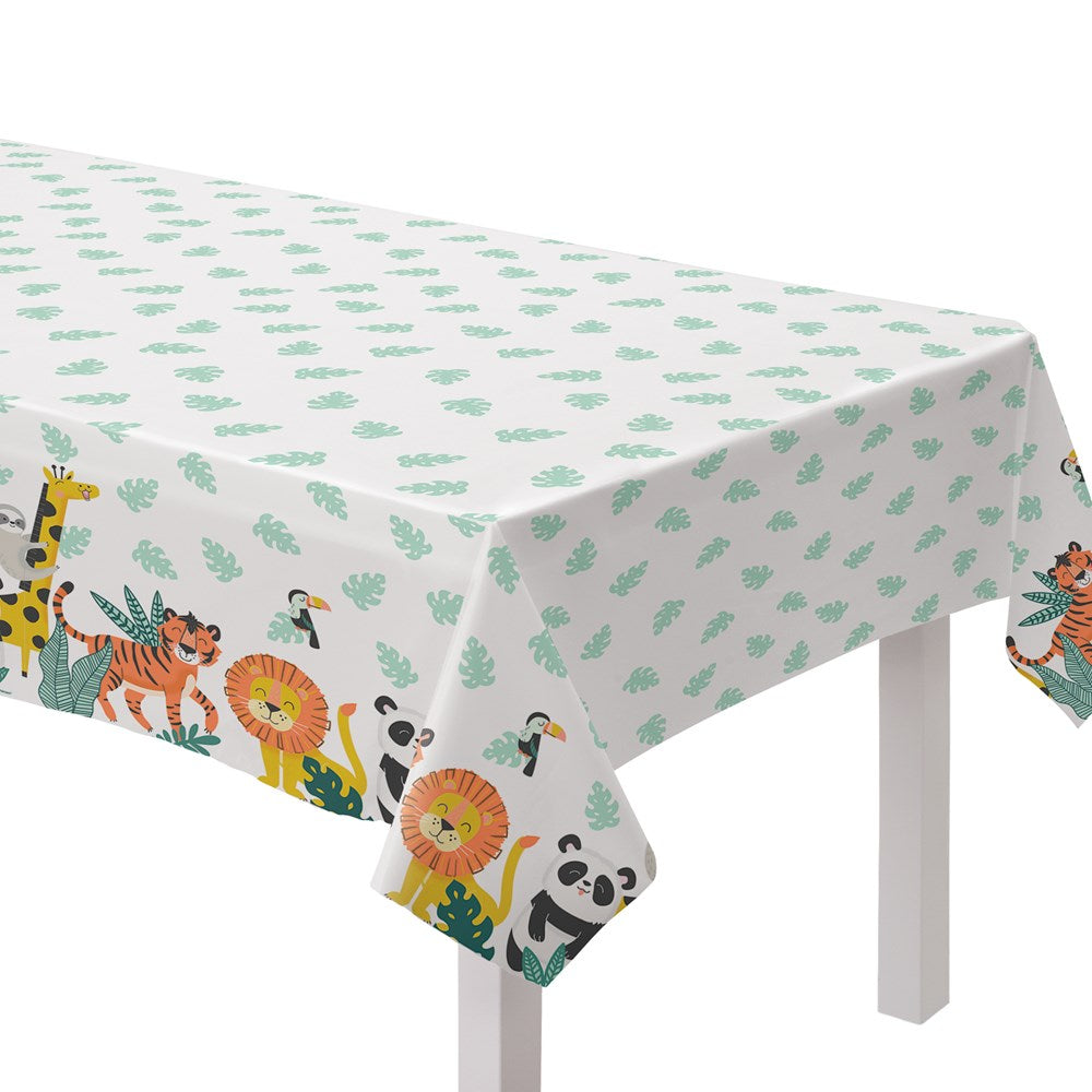 Rectangular plastic table cover with white background, green leaf patterns, and colorful cartoon jungle animals along the.