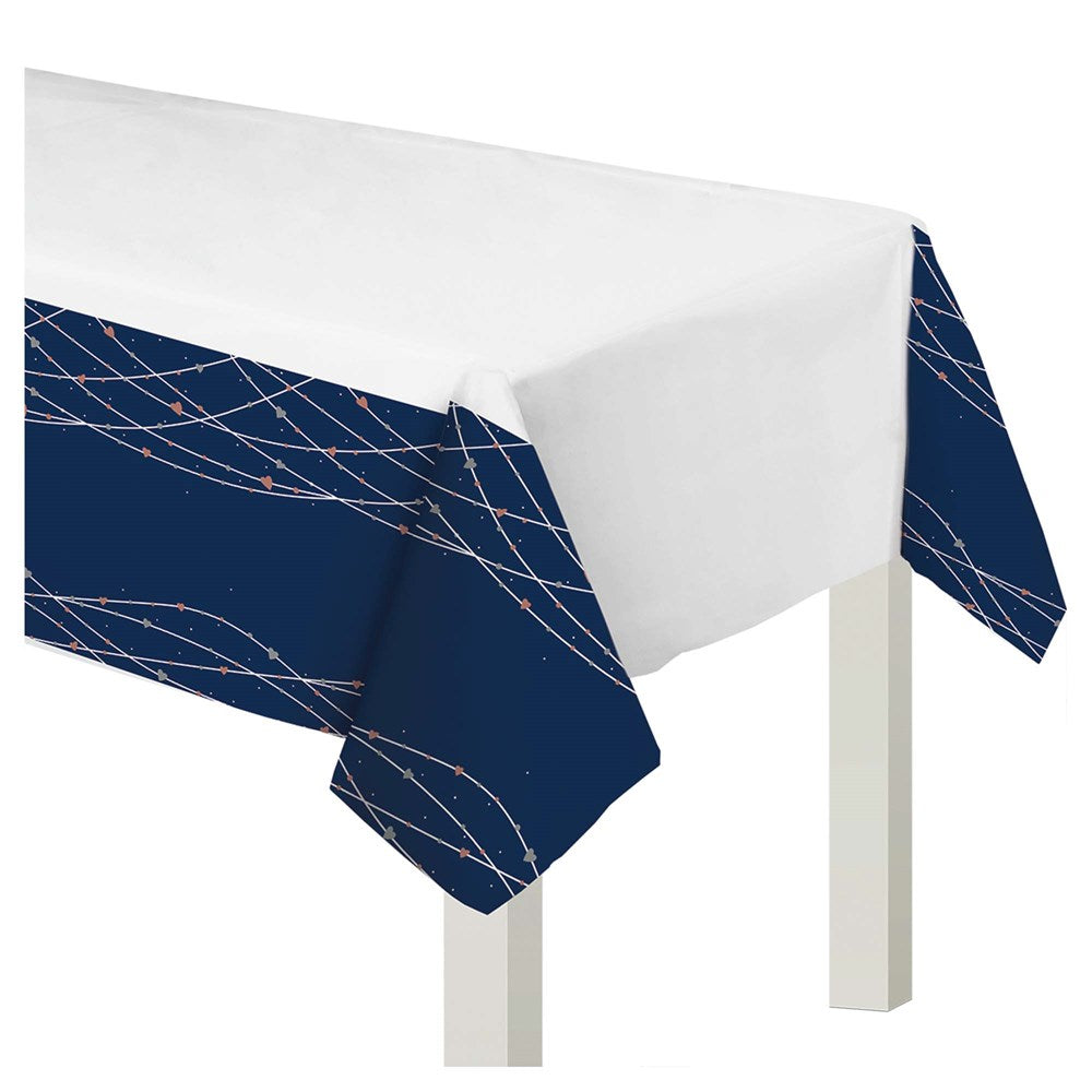 White plastic table cover with navy blue borders featuring delicate silver line patterns.
