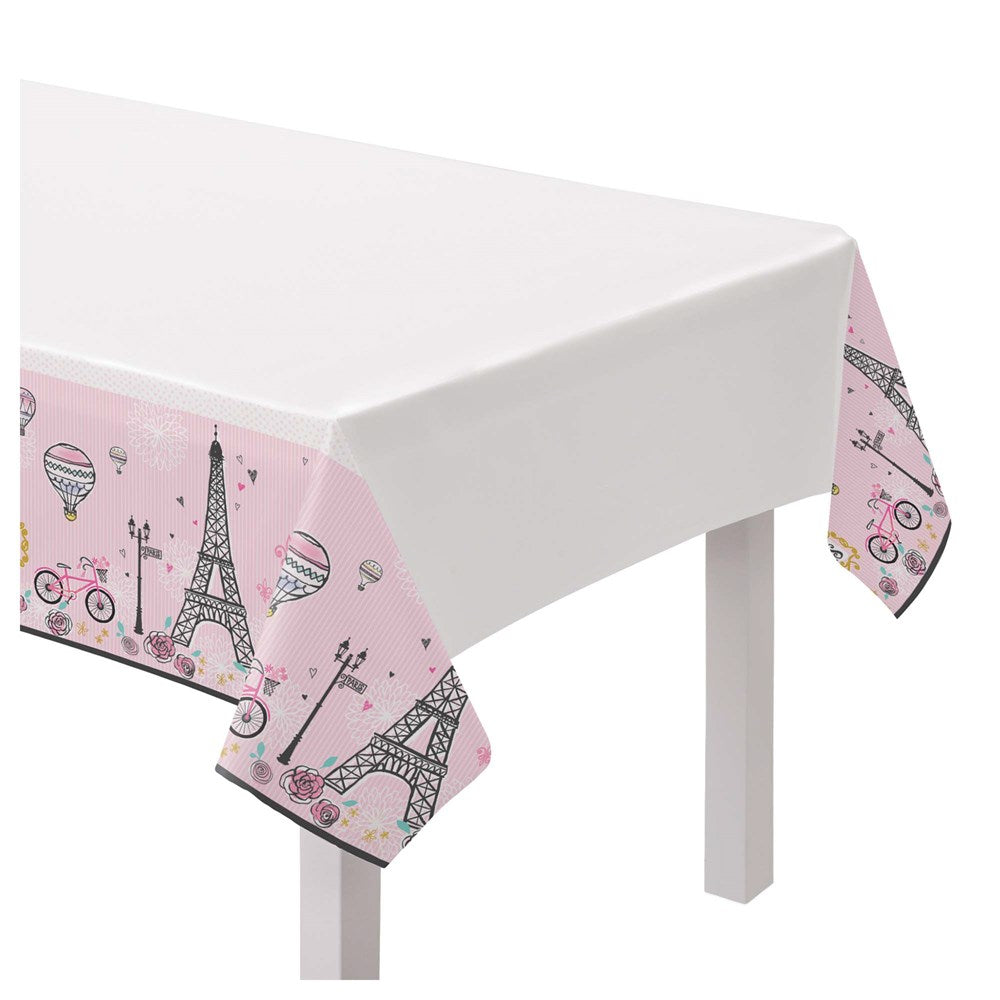 White plastic tablecover with pink edges featuring Eiffel Tower, hot air balloons, and bicycles designs.