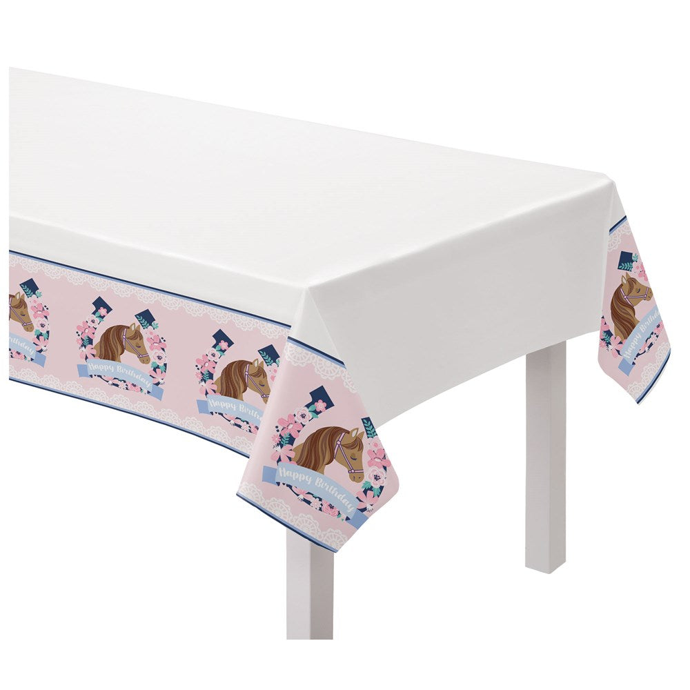 White plastic table cover with pastel pink border featuring horses and blue horseshoes designs.