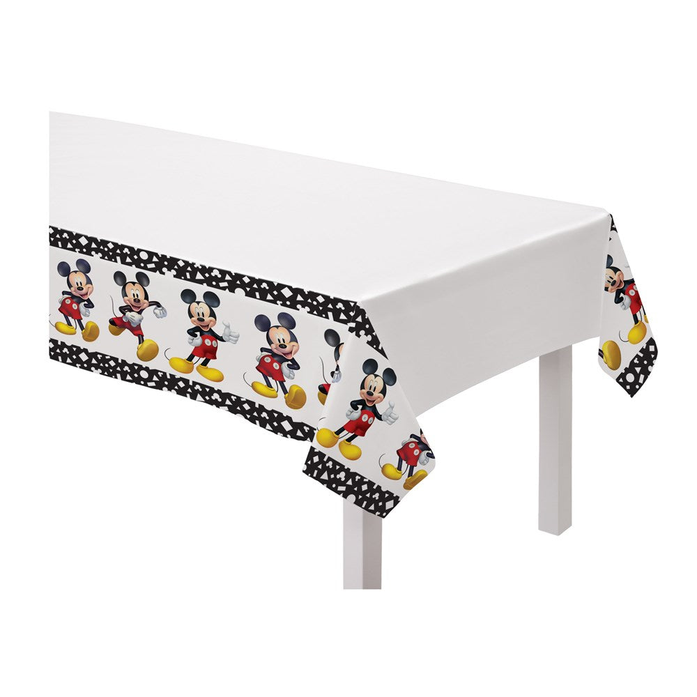White plastic rectangular table cover with repeating colorful Mickey Mouse poses and black polka dot border.